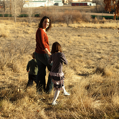 Lauren and her kids walking in a field